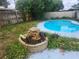 Backyard pool with a decorative rock waterfall feature and surrounding plants at 2083 Envoy Ct, Clearwater, FL 33764