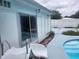 Poolside view of the home exterior, showing sliding glass doors at 2083 Envoy Ct, Clearwater, FL 33764