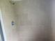 This remodeled shower features beige tile throughout at 2083 Envoy Ct, Clearwater, FL 33764