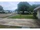 A cozy home in a tranquil neighborhood, featuring a lush lawn and mature trees at 2083 Envoy Ct, Clearwater, FL 33764