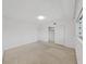 Spacious bedroom with a closet, neutral carpet, white walls, and natural light at 2402 Ecuadorian Way # 40, Clearwater, FL 33763