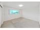 Neutral bedroom offering a large window for natural light and a serene atmosphere at 2402 Ecuadorian Way # 40, Clearwater, FL 33763