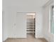 Walk-in closet features built-in shelving for optimal storage in a light and bright room at 2402 Ecuadorian Way # 40, Clearwater, FL 33763