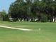 Scenic golf course with a sand trap, mature trees, and well-manicured greens at 2402 Ecuadorian Way # 40, Clearwater, FL 33763
