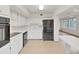 Updated kitchen with white cabinets, a black refrigerator, and neutral flooring at 2402 Ecuadorian Way # 40, Clearwater, FL 33763