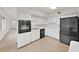 Well-lit kitchen featuring an oven, white cabinets, and sleek black appliances at 2402 Ecuadorian Way # 40, Clearwater, FL 33763