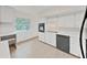 Kitchen with white cabinets, black appliances, and a built-in breakfast nook at 2402 Ecuadorian Way # 40, Clearwater, FL 33763