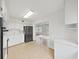 Bright kitchen features white cabinets, black appliances, and an open layout at 2402 Ecuadorian Way # 40, Clearwater, FL 33763