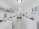 White laundry room with multiple washing machines and visible utility connections at 2402 Ecuadorian Way # 40, Clearwater, FL 33763