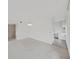 Bright and empty living room with carpet, large windows, and view to kitchen area at 2402 Ecuadorian Way # 40, Clearwater, FL 33763