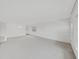 An empty living room with bright windows and neutral carpet near the entrance at 2402 Ecuadorian Way # 40, Clearwater, FL 33763