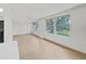 Sunlit living room with large windows, neutral tile flooring and a ceiling fan at 2402 Ecuadorian Way # 40, Clearwater, FL 33763
