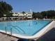 Community swimming pool with pristine, clear water and poolside seating available at 2402 Ecuadorian Way # 40, Clearwater, FL 33763