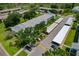 Aerial view of the community with a mix of residential buildings, lush trees, parking, and landscaped areas at 306 Martha Ln # 42, Oldsmar, FL 34677