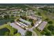 Aerial view of condos with assigned parking surrounded by mature trees and maintained landscaping at 306 Martha Ln # 42, Oldsmar, FL 34677
