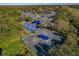 Wide aerial view of community tennis and pickleball courts amid lush greenery at 306 Martha Ln # 42, Oldsmar, FL 34677