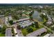 Scenic aerial view of condos near a small lake surrounded by lush trees and manicured grounds at 306 Martha Ln # 42, Oldsmar, FL 34677