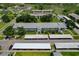 Aerial view of the community with multiple buildings, parking areas, and mature trees under a clear sky at 306 Martha Ln # 42, Oldsmar, FL 34677