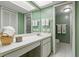 Bright bathroom features a large countertop, white tile flooring, and a walk in shower at 306 Martha Ln # 42, Oldsmar, FL 34677