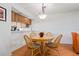 Dining area includes a round wood table and four chairs, with a view into the kitchen at 306 Martha Ln # 42, Oldsmar, FL 34677