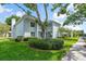 Well-maintained two-story building with lush landscaping, mature trees, and a sidewalk in a serene setting at 306 Martha Ln # 42, Oldsmar, FL 34677