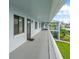 Exterior hallway showing the entrance to units with the view of manicured lawns and blue skies at 306 Martha Ln # 42, Oldsmar, FL 34677
