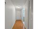 Bright hallway features wood flooring, a white door and closet, and access to other rooms at 306 Martha Ln # 42, Oldsmar, FL 34677