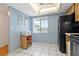 Bright eat-in kitchen features tile floors, black appliances, and a window with backyard views at 306 Martha Ln # 42, Oldsmar, FL 34677
