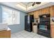 Kitchen featuring black appliances, light blue walls, and tile flooring at 306 Martha Ln # 42, Oldsmar, FL 34677