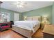 Spacious bedroom with a ceiling fan, wooden floors, dresser, and a large bed at 306 Martha Ln # 42, Oldsmar, FL 34677