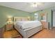 Comfortable bedroom features hardwood flooring, a ceiling fan and ensuite bathroom at 306 Martha Ln # 42, Oldsmar, FL 34677