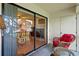 Inviting patio with wicker furniture and a seamless transition to the bright interior, as seen through the sliding glass door at 306 Martha Ln # 42, Oldsmar, FL 34677