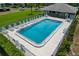 Relaxing community pool with lounge chairs, tables, and a well-maintained surrounding area at 306 Martha Ln # 42, Oldsmar, FL 34677