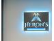 Close-up of a sign for Heron's Bar & Grille with blue lighting and heron logo at 306 Martha Ln # 42, Oldsmar, FL 34677