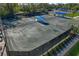 Aerial shot of meticulously maintained tennis courts with covered seating area at 306 Martha Ln # 42, Oldsmar, FL 34677