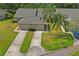 Aerial view of a charming neighborhood with well-manicured lawns and mature palm trees, adding to the curb appeal at 3274 Lori Ln # 2, New Port Richey, FL 34655