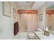 Compact bathroom with tile shower and vanity, complemented by neutral tones and decorative artwork at 3274 Lori Ln # 2, New Port Richey, FL 34655