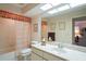 Functional bathroom featuring a tub-shower, a toilet, and a vanity with ample counter space and a large mirror at 3274 Lori Ln # 2, New Port Richey, FL 34655