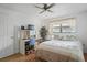 Comfortable bedroom with a ceiling fan, a desk, and a window with curtains for natural light and privacy at 3274 Lori Ln # 2, New Port Richey, FL 34655