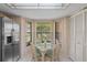 Cozy breakfast nook with a glass-top table, wicker chairs, and a bay window overlooking the lush outdoors at 3274 Lori Ln # 2, New Port Richey, FL 34655