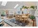 Open dining area with skylights and vaulted ceiling, seamlessly flowing into the adjacent living spaces at 3274 Lori Ln # 2, New Port Richey, FL 34655