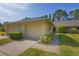 Charming home with a two-car garage, and well-maintained landscaping, situated on a green lawn and sunny skies at 3274 Lori Ln # 2, New Port Richey, FL 34655
