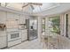 Eat-in kitchen features white appliances, light countertops, and bright dining nook at 3274 Lori Ln # 2, New Port Richey, FL 34655