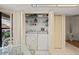 Convenient laundry area featuring a washer, dryer, storage shelves, and easy access from the breakfast nook at 3274 Lori Ln # 2, New Port Richey, FL 34655