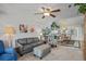 Cozy living room featuring stylish furniture, soft carpeting, and abundant natural light creating an inviting atmosphere at 3274 Lori Ln # 2, New Port Richey, FL 34655