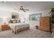 Comfortable main bedroom with a ceiling fan, carpet flooring, natural light and classic wooden furniture accents at 3274 Lori Ln # 2, New Port Richey, FL 34655
