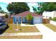 Aerial shot of a single-Gathering home with a well-maintained yard, driveway, and attached garage at 3315 W Saint John St, Tampa, FL 33607