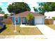 An aerial view of a single-Gathering home showcasing the roof, yard, driveway, and surrounding neighborhood at 3315 W Saint John St, Tampa, FL 33607