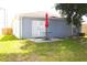 Cozy backyard patio with table, umbrella and grassy area perfect for outdoor entertaining at 3315 W Saint John St, Tampa, FL 33607