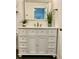 Close up of white bathroom vanity with framed mirror and dual faucets with decorative accents at 3315 W Saint John St, Tampa, FL 33607